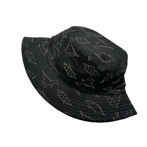 Detail of waterproof black sun hat featuring white cartoon dinosaur line drawings