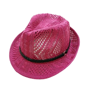 Close-up of rose pink crochet sun hat featuring hollow knit pattern and black band