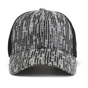 Detail view of woven baseball cap texture with shimmering sequins and GLF lettering