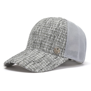 Chic tweed and grey mesh baseball cap featuring a golden M logo and wide brim for sun protection