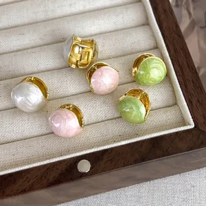 French bean earrings in gold metal with pink, white, and green glazed drop finish
