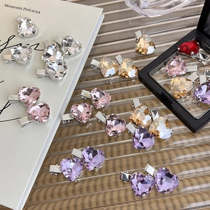 Detailed view of colorful heart-shaped crystal hairpins with polished metal bases