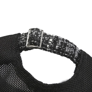 Detail of adjustable silver buckle and tweed strap on breathable mesh baseball cap