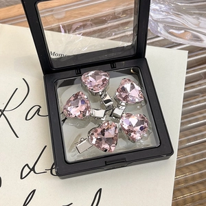 Set of five pink heart crystal hairpins displayed in a black floating jewelry storage box
