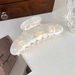 Close-up of pearl white marble acetate hair claw clip with gold France Handmade lettering