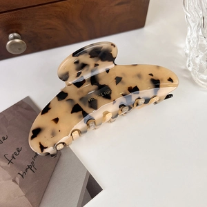 Close-up of brown tortoiseshell acetate hair claw clip with France Handmade gold lettering