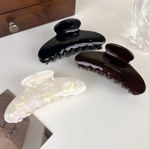 Elegant large acetate hair claws in black, brown, and cream white pearl finish