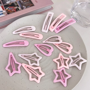 Pink gradient star and heart hair clips set of 14 pieces in a ceramic dish