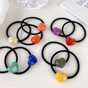 Colorful acrylic heart hair ties with elastic rubber bands and golden lettering