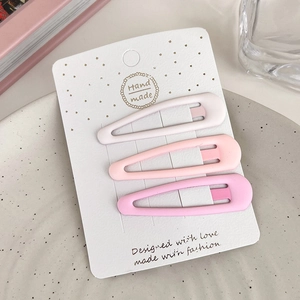 Detailed view of three matte pink gradient star hair clips on a handmade card display