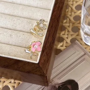 Elegant asymmetrical zircon flower stud earrings with pink enamel and pearl accents