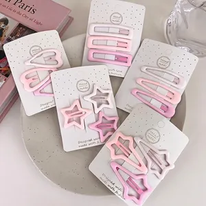 Pink matte gradient star and heart hair clips set displayed on decorative jewelry tray