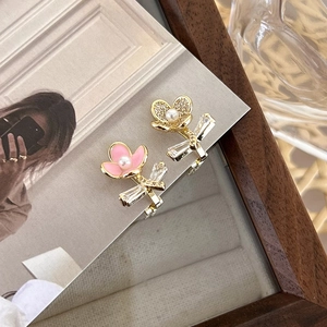 Asymmetric zircon flower earrings with pink enamel petals and pearl center on art card