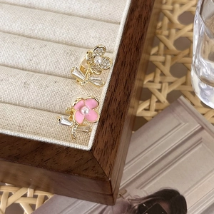 Detailed macro of zircon flower earrings with pearls in a velvet jewelry display box