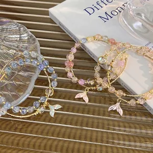 Three-piece set of beaded bracelets with mermaid tail pendants in pink, blue, and champagne