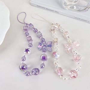 Macro detail of sweet purple and pink beaded phone straps with cute butterfly bow charms