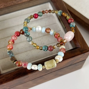 Ethnic bohemian beaded bracelet with natural stones and irregular pearls in a wooden box
