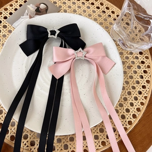 Pink and black satin bow hair clips with silver star rhinestones and long streamers
