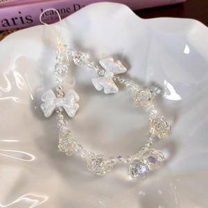 Detailed macro view of white bow and iridescent rose beads on sweet style phone charm