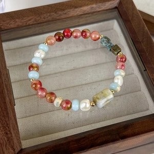 Detailed close-up of ethnic beaded bracelet with marble pendant on velvet jewelry box