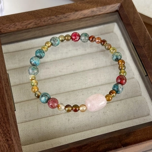 Macro shot of colorful natural gemstones and pink crystal on retro ethnic style bracelet