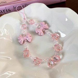 Detail of sweet pink beaded phone strap with bow and iridescent rose charm