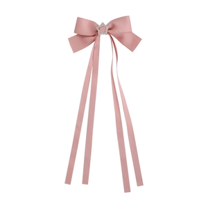 Pink satin bow hair clip with star rhinestone and long ribbons on white background