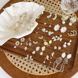 Elegant floral pearl drop earrings set in gold finish with vintage shell accents