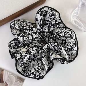 Detail of vintage floral pattern large scrunchie with glossy black and white fabric