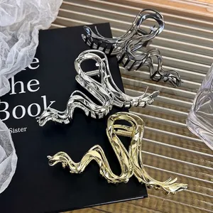 Minimalist liquid metal wave hair claw clips in gold and silver for thick hair