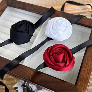 Elegant vintage rose choker set with satin ribbons in black, white, and dark red colors