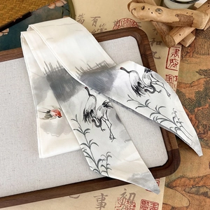 Detailed pattern of white cranes and ink bamboo on a Chinese style silk ribbon scarf