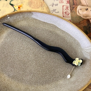Detailed shot of black sandalwood hair stick with jasmine flower and white pearl bead