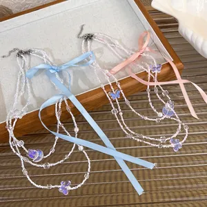Three-layer balletcore beaded necklace with satin bows and butterfly pendants in pink and blue