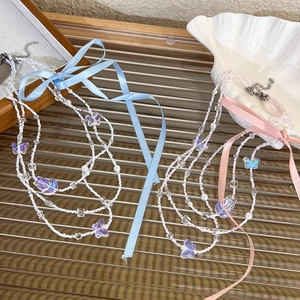 Detailed view of balletcore style beaded necklaces with blue and pink silk ribbon bows