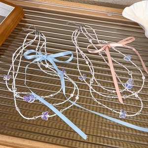 Three-layer beaded necklace with pink and blue ribbon bows and butterfly pendants