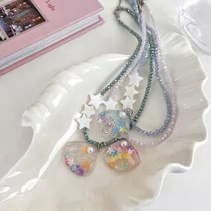 Y2K style beaded necklace with star charms and seashell pendants in blue and purple colors