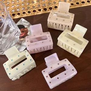 Elegant square acetate claw clips set with rhinestones in cream, purple, and orange colors