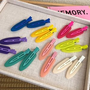 Set of 14 colorful matte seamless hair clips in pastel tones on a decorative tray