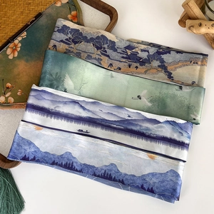 Detailed view of three oriental style silk scarves with crane and landscape patterns