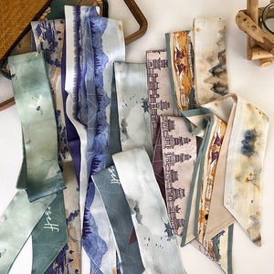 Flat lay of Chinese style silk skinny scarves featuring crane and landscape prints