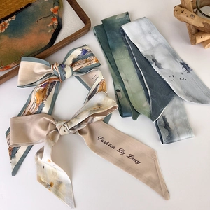 Detail of elegant Chinese style silk twilly scarf with landscape ink patterns
