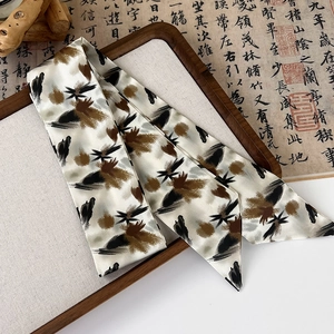 Close-up of retro silk ribbon with ink wash art pattern on a decorative wooden tray