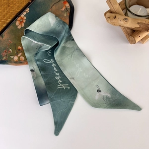 Detail of teal gradient silk twilly with white crane pattern and be yourself text