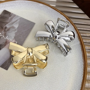 Elegant metal bow hair claw clips in gold and silver finish for sleek hairstyles