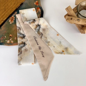 Detail view of a long silk scarf featuring Chinese ink wash painting and pointed ends