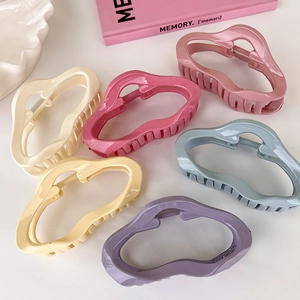 Detailed arrangement of six colorful irregular acrylic claw clips on a white background