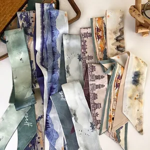 Chinese landscape print silk scarf for hair or bags displayed on a wooden tray