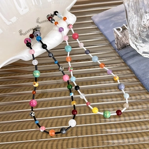 Macro view of colorful beaded necklaces with silver adjustable chains and lobster clasps
