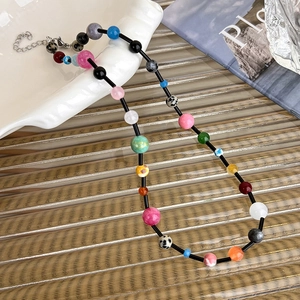 Detail of bohemian colorful beaded necklace with resin stones and silver lobster clasp